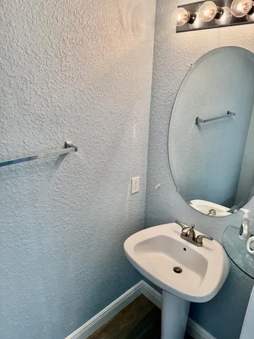 a view of staircase with wooden floor and white walls