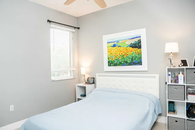 a bedroom with a bed and a window