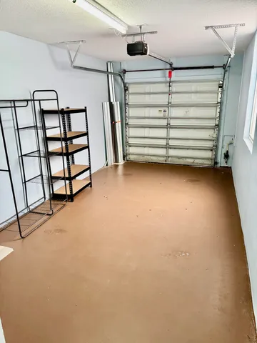 an aerial view of a house with swimming pool and large trees