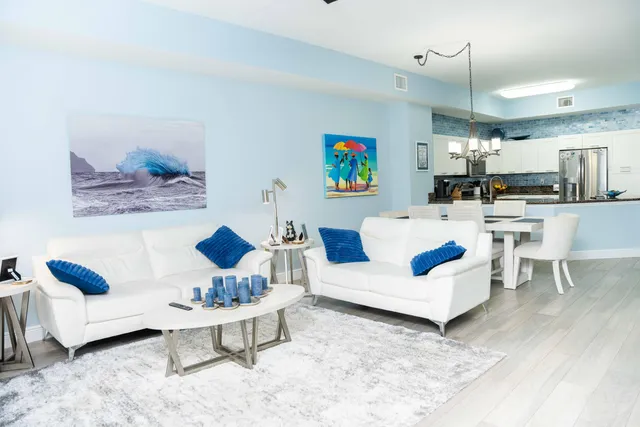 a living room with furniture and kitchen view