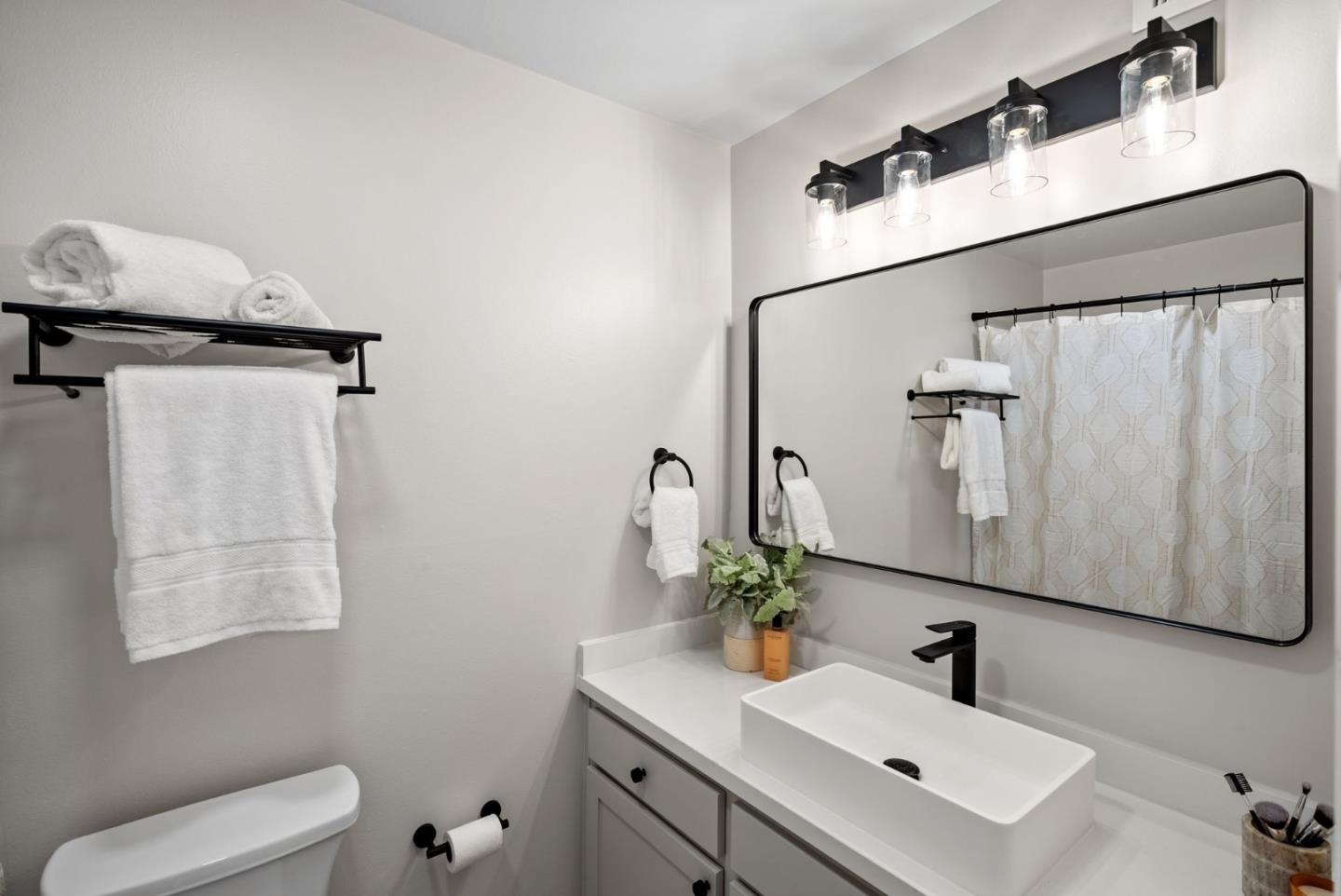 1925 46th Avenue, Unit 172 Capitola, CA 95010 - Photo 11 of 26 a bathroom with a sink and mirror with toilet