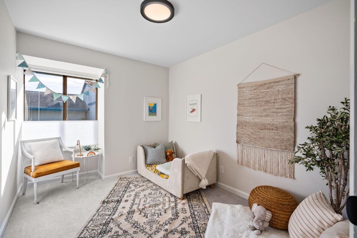 1925 46th Avenue, Unit 172 Capitola, CA 95010 - Photo 13 of 26 a living room with furniture and a potted plant