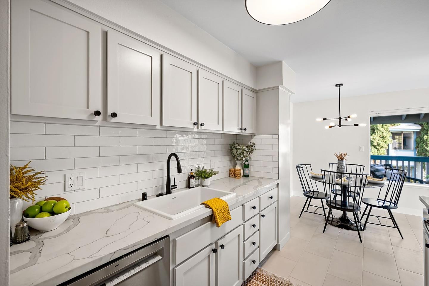 1925 46th Avenue, Unit 172 Capitola, CA 95010 - Photo 6 of 26 a kitchen with white cabinets and wooden floor