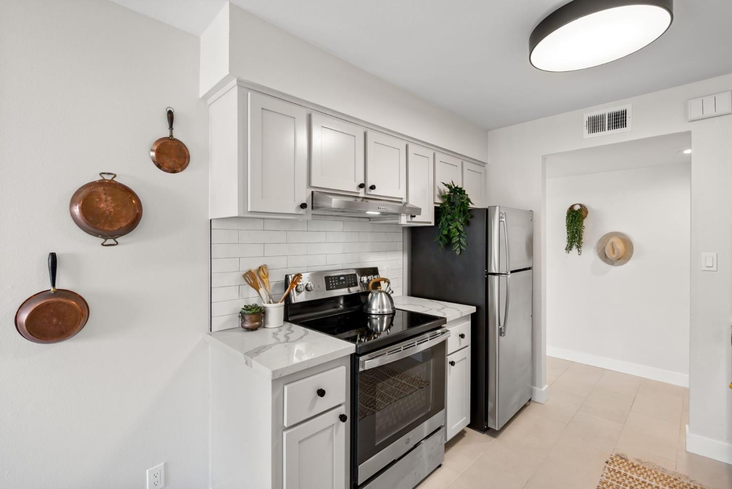1925 46th Avenue, Unit 172 Capitola, CA 95010 - Photo 8 of 26 a kitchen with stainless steel appliances granite countertop a sink a stove and refrigerator