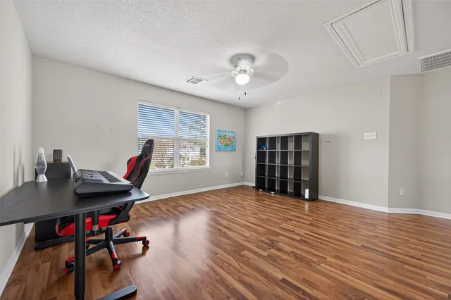 a bathroom with a sink a toilet and a large mirror next to a window