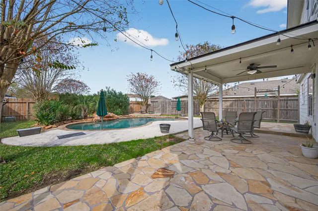 a view of a house with swimming pool and a yard