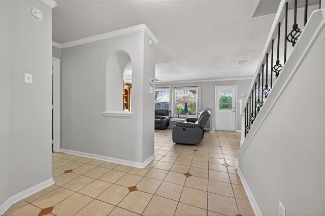 a living room with furniture and flowers