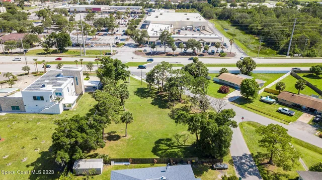 an aerial view of residential houses with outdoor space and swimming pool