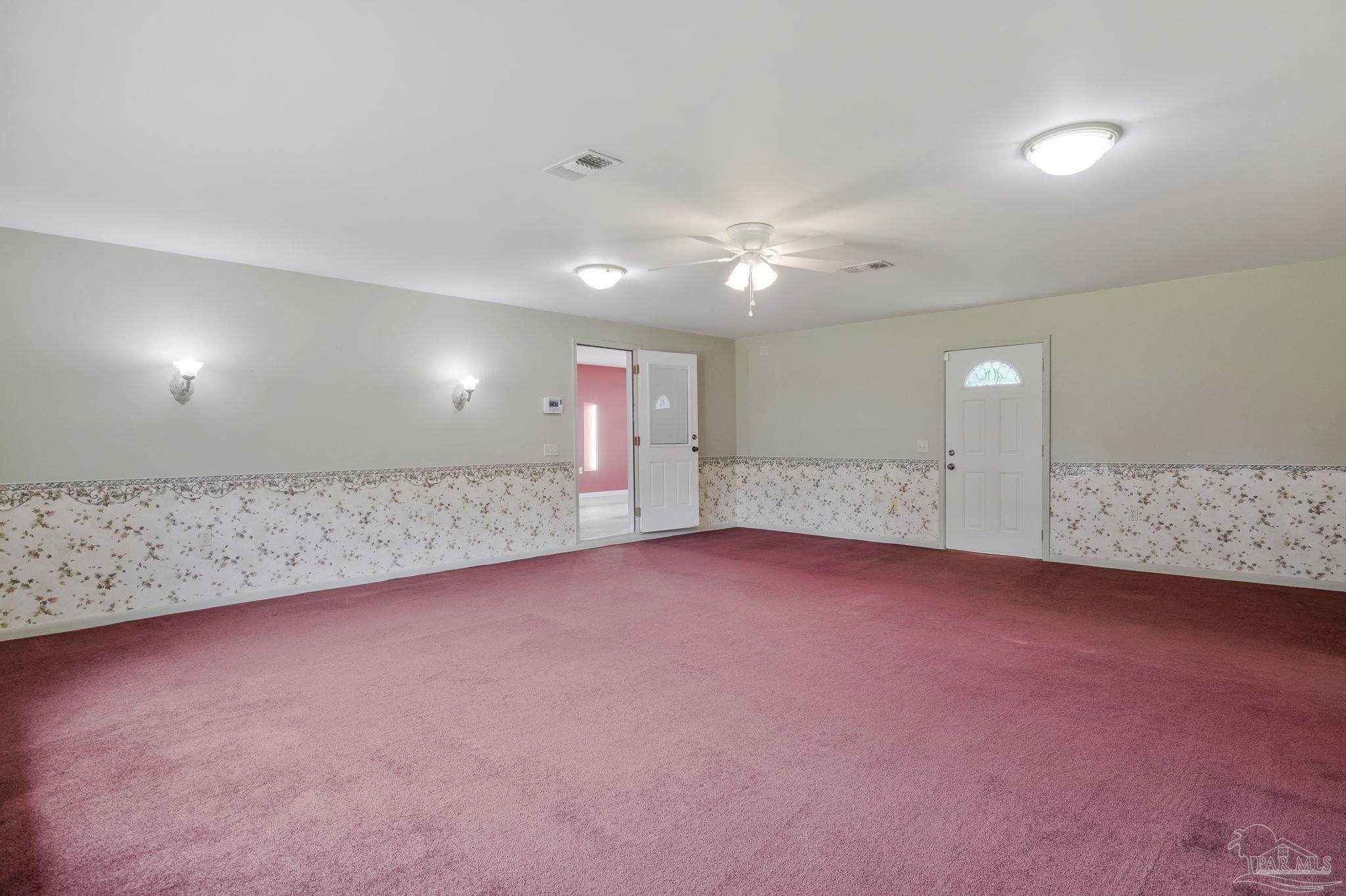 4411 Pace Lane Pace, FL 32571 - Photo 15 of 68 an empty room with chandelier fan and windows