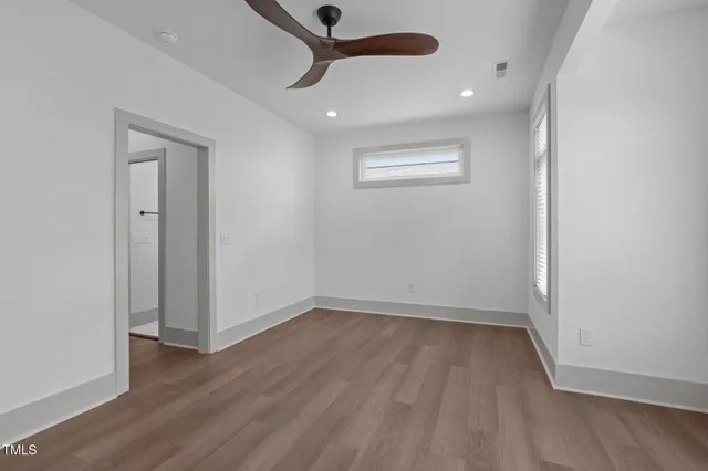 wooden floor in an empty room with a window