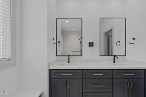 a bathroom with a double vanity sink and mirror