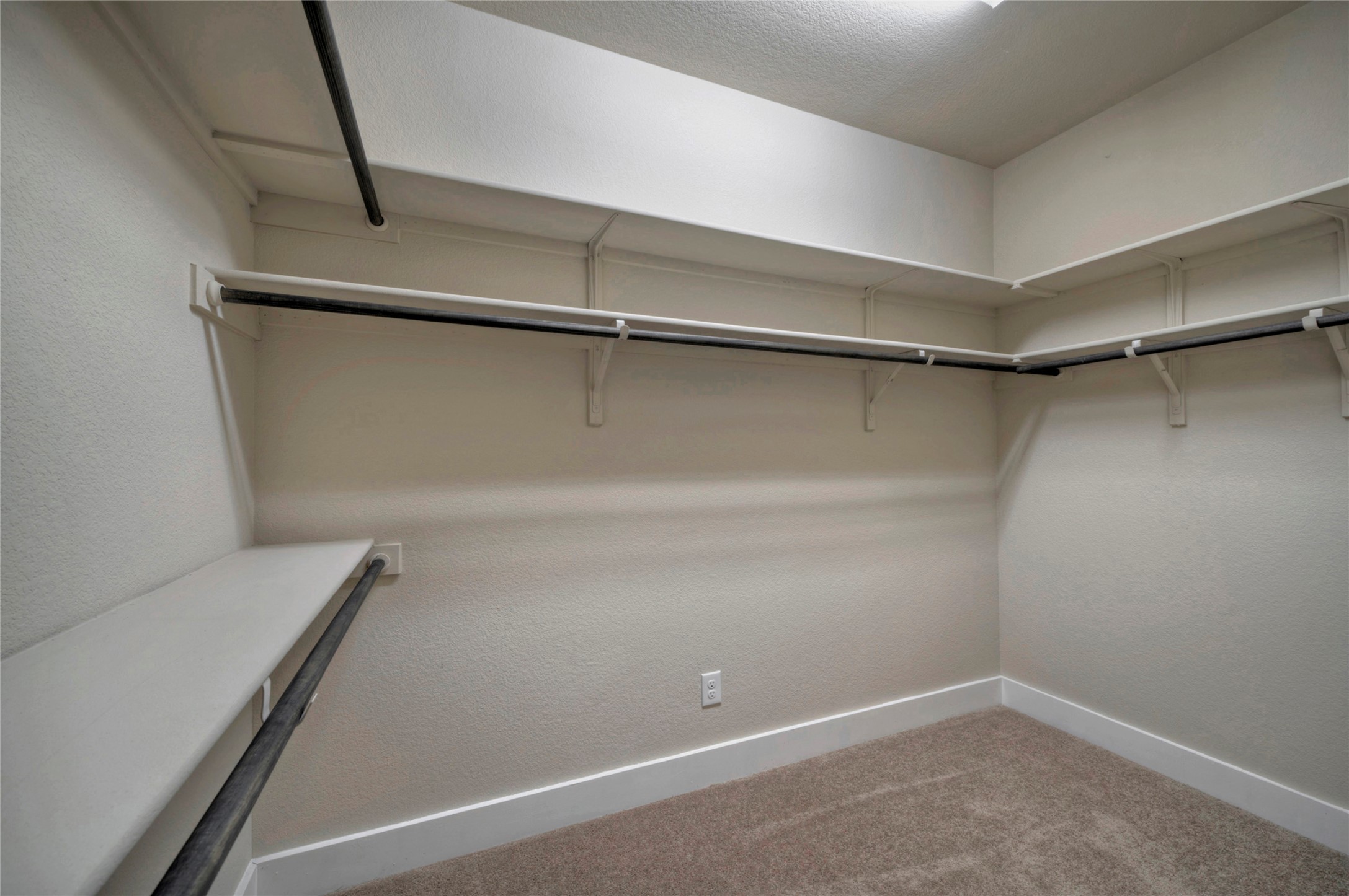 508 High Tech Drive, Unit B Georgetown, TX 78626 - Photo 18 of 24 Ample shelving and hanging rods create an organized walk-in closet space.