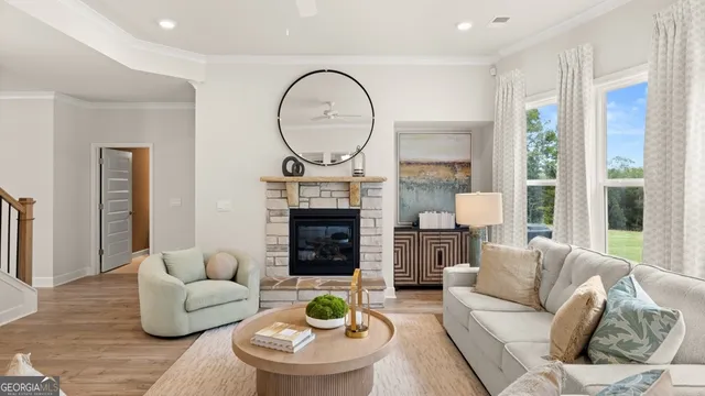 a living room with furniture a fireplace and a large window