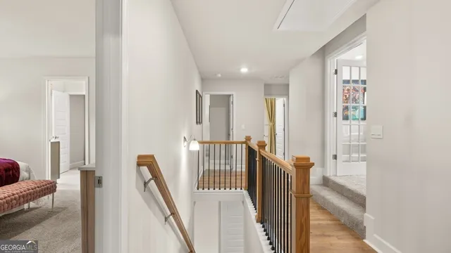 a view of a hallway with furniture and stairs