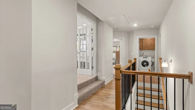 a view of a hallway with washer and dryer