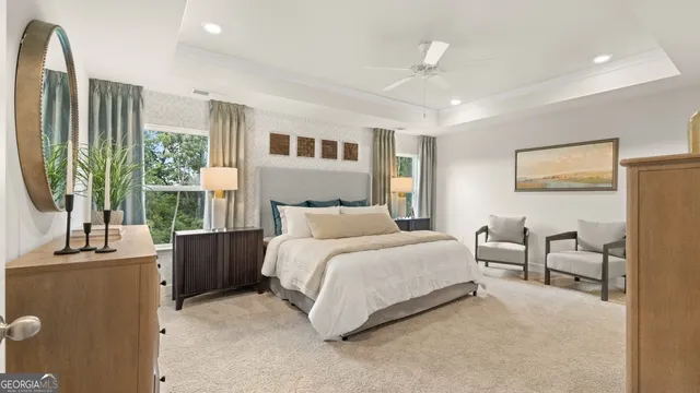 a bedroom with furniture and a large window