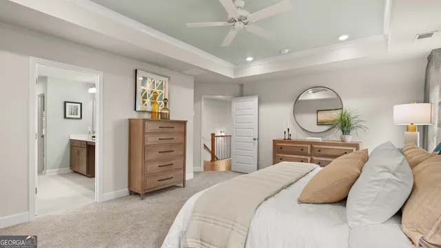 a bedroom with a bed a mirror on dresser and a chandelier