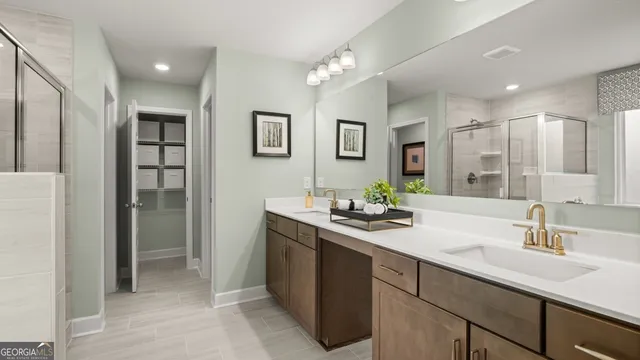 a bathroom with a sink double vanity and a shower