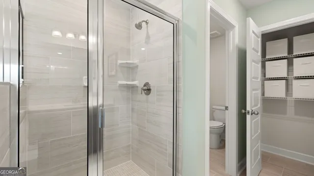 a bathroom with a glass shower door