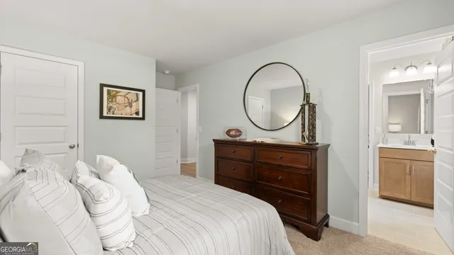 a bedroom with a bed mirror and a dresser