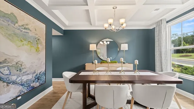 a view of a dining room with a table and chairs