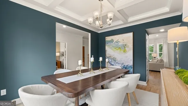 a view of a dining room with furniture a chandelier and wooden floor