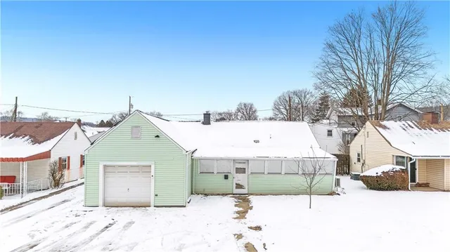 a view of a house with a snow in front of it