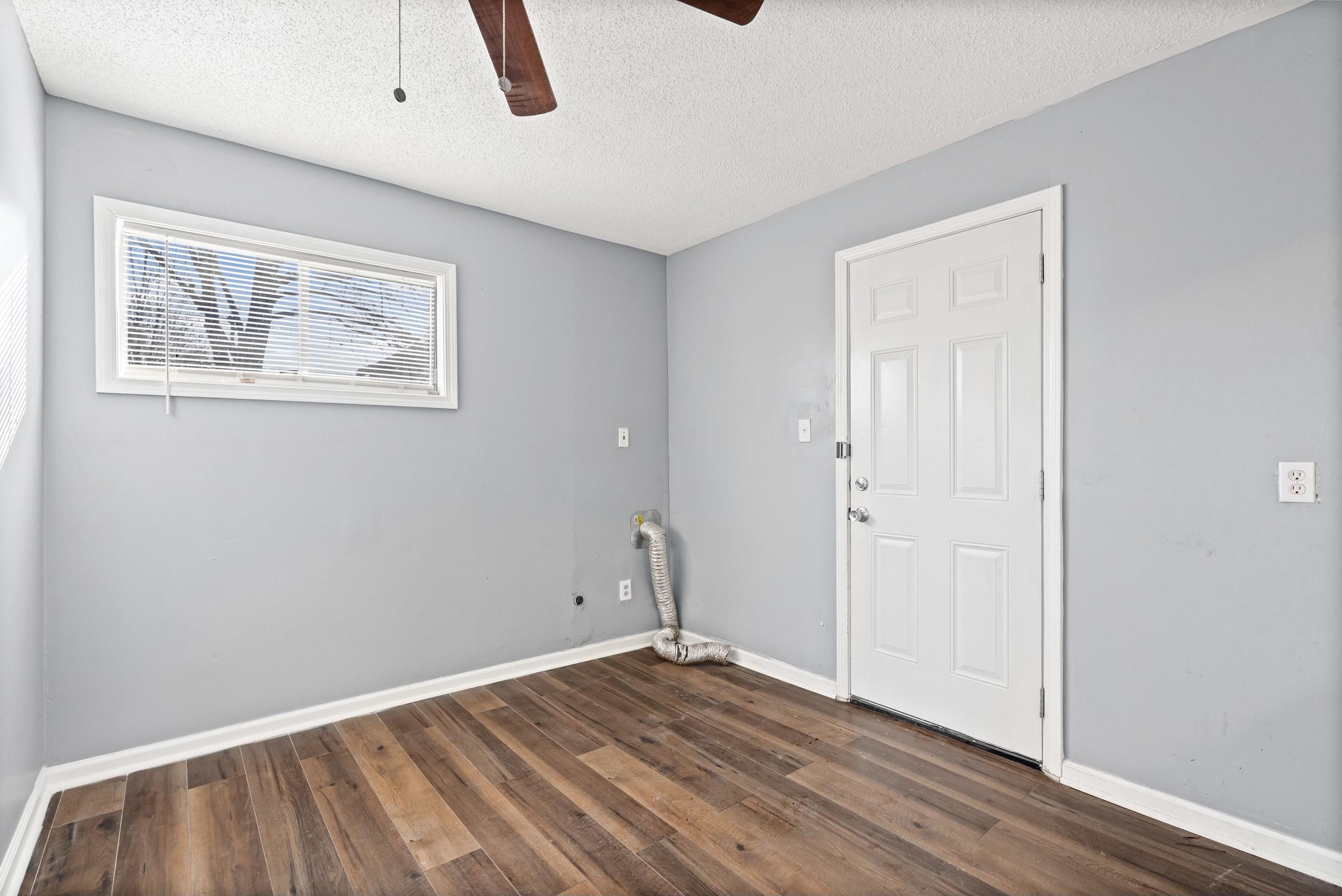 1848 Wynton Street Memphis, TN 38106 - Photo 13 of 22 Laundry room featuring dark wood-style flooring, a textured ceiling, ceiling fan, and electric dryer hookup