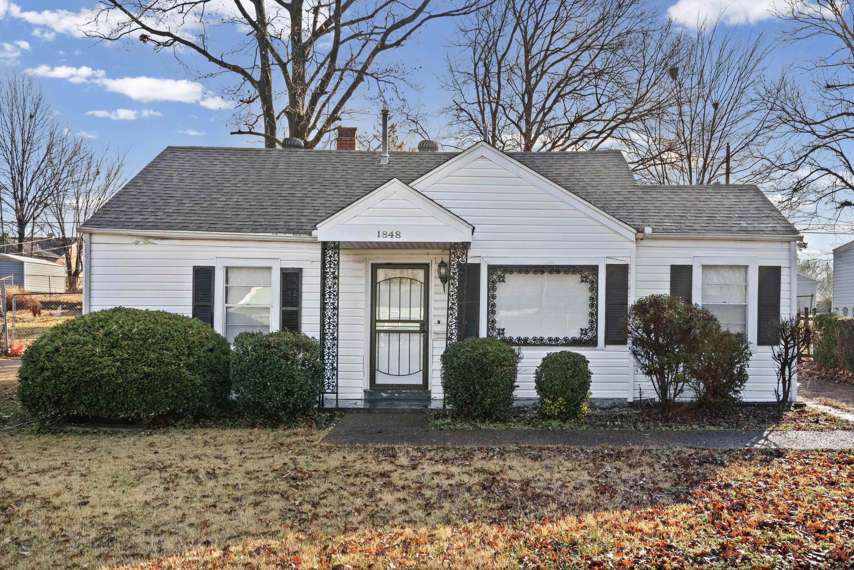 1848 Wynton Street Memphis, TN 38106 - Photo 3 of 22 View of front of house with a shingled roof and a chimney