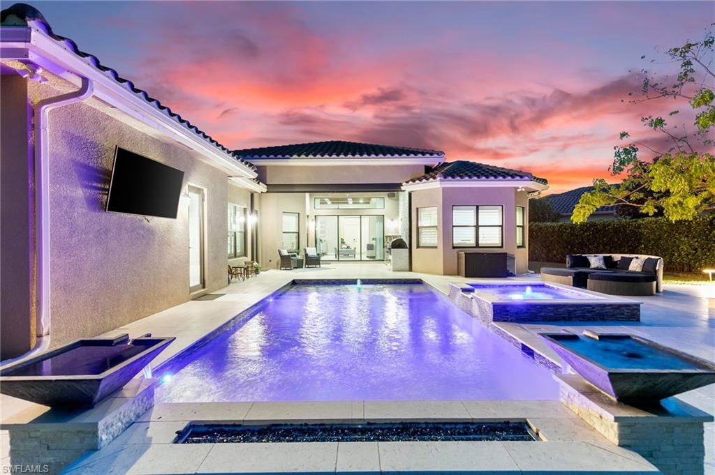 4605 Azalea Drive Naples, FL 34119 - Photo 11 of 50 a swimming pool with outdoor seating