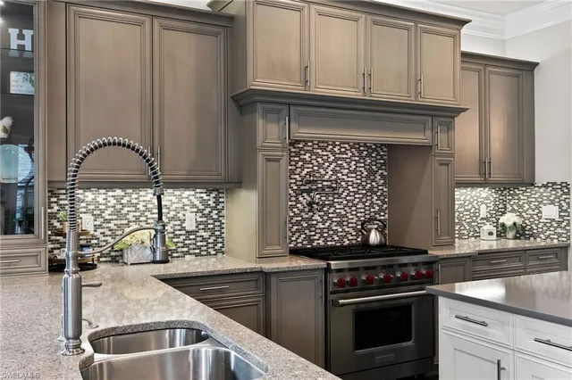 a kitchen with granite countertop a stove and a sink