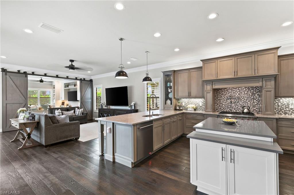 4605 Azalea Drive Naples, FL 34119 - Photo 23 of 50 a kitchen with counter top space cabinets and stainless steel appliances