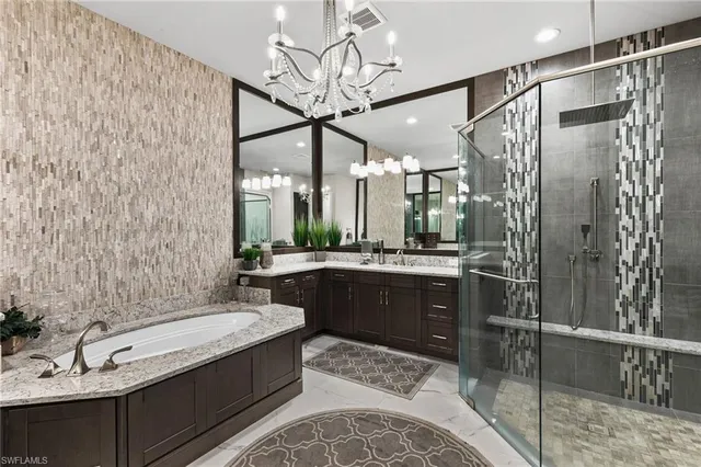 a bathroom with a double vanity sink mirror and shower