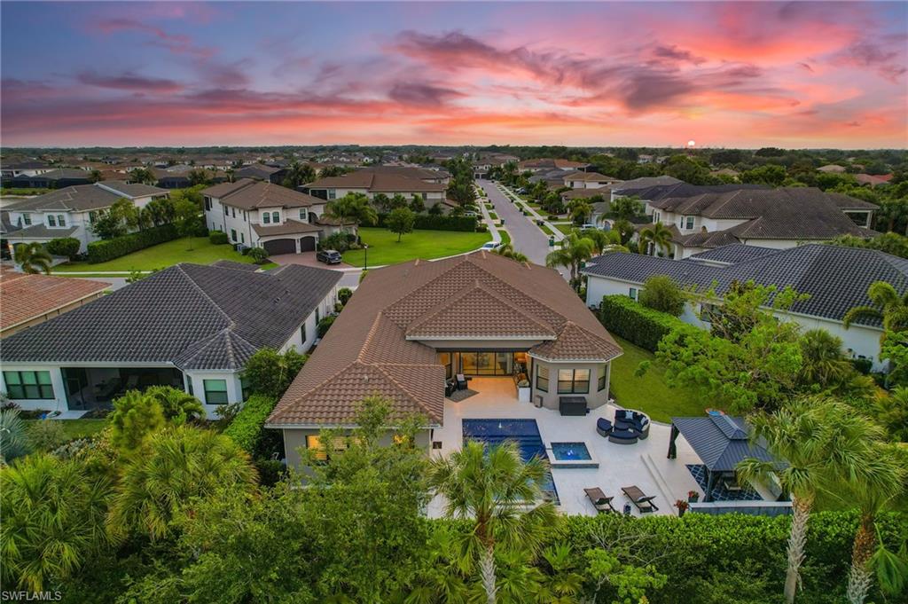 4605 Azalea Drive Naples, FL 34119 - Photo 38 of 50 an aerial view of a house with a garden space and lake view in back