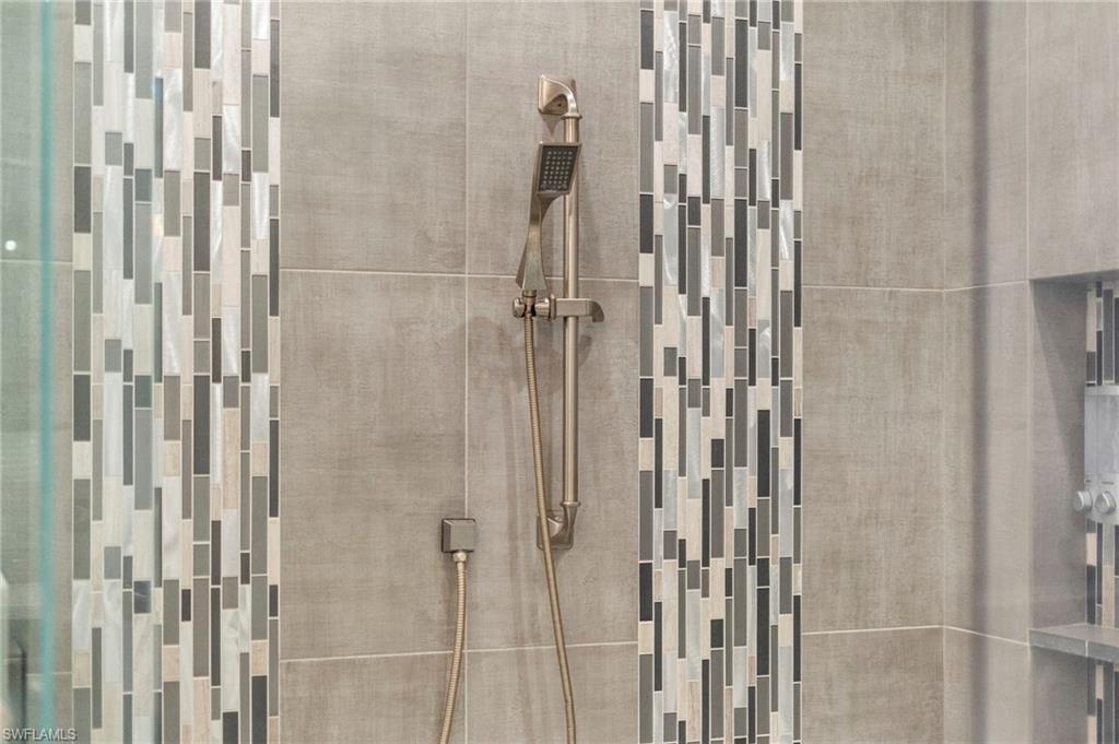 4605 Azalea Drive Naples, FL 34119 - Photo 41 of 50 a bathroom with a glass shower door