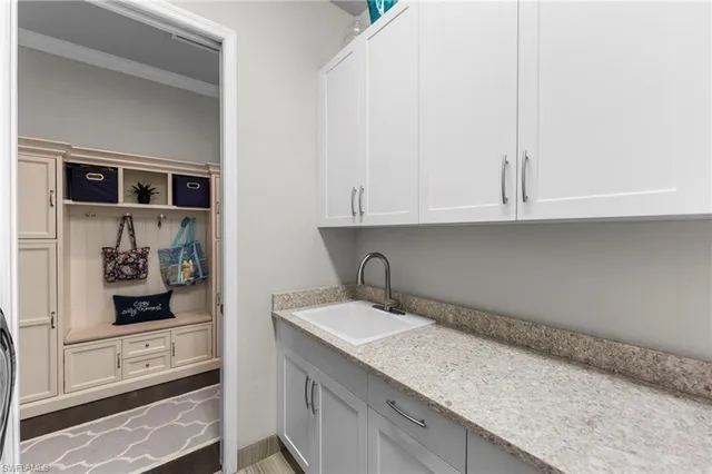 a kitchen with a sink and cabinets