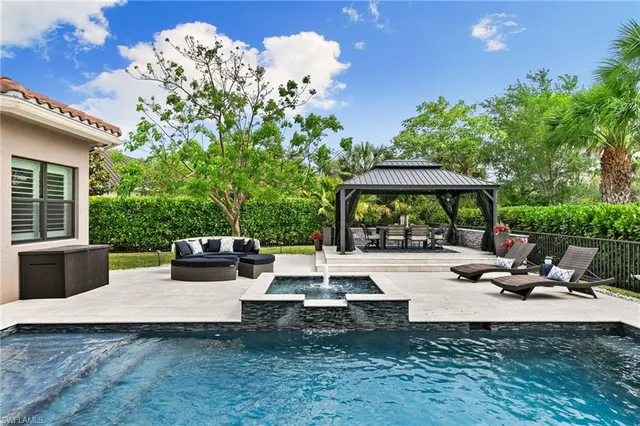 a view of a patio with table and chairs potted plants with wooden fence
