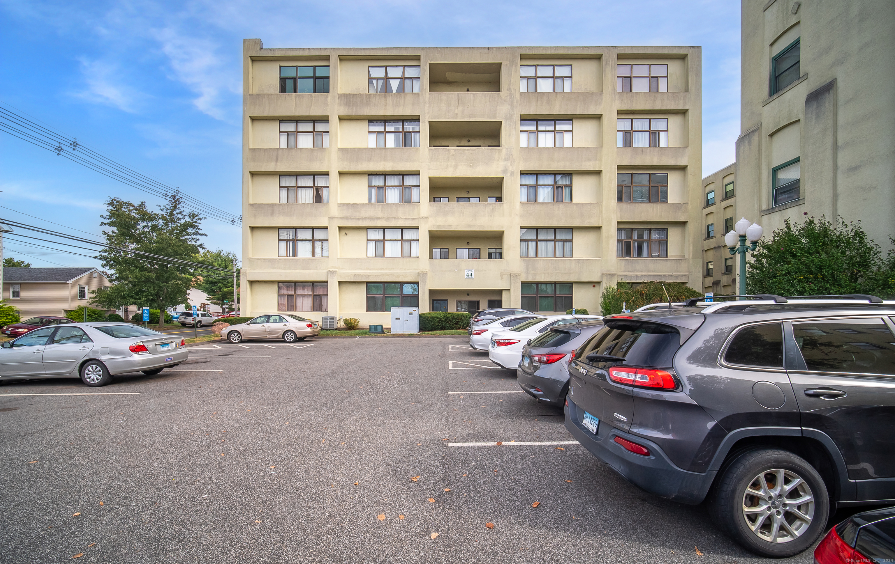 105 Judd Square, Unit 105 Wallingford, CT 06492 - Photo 1 of 1 a view of a cars park in front of a building
