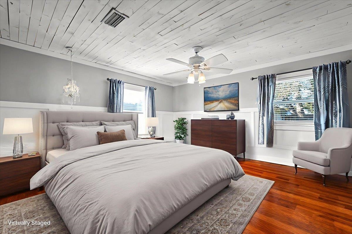 979 Altara Avenue St. Augustine, FL 32086 - Photo 13 of 27 a spacious bedroom with a large bed and a chandelier