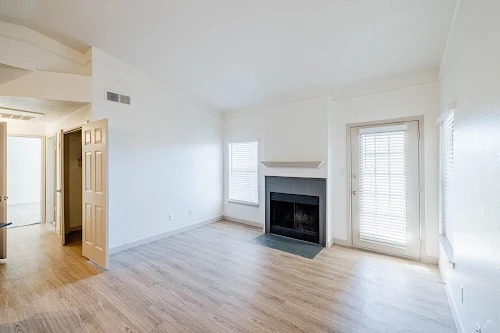 11908 Anderson Mill Road, Unit 421 Cedar Park, TX 78613 - Photo 11 of 21 a view of an empty room with wooden floor fireplace and a window