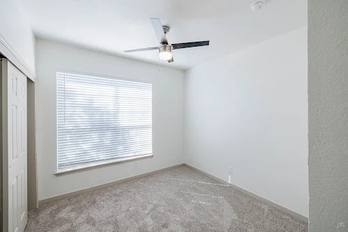 11908 Anderson Mill Road, Unit 421 Cedar Park, TX 78613 - Photo 14 of 21 an empty room with windows and fan