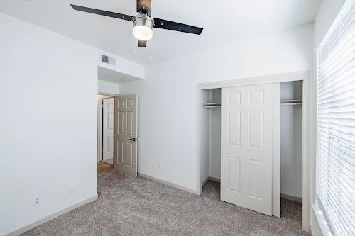11908 Anderson Mill Road, Unit 421 Cedar Park, TX 78613 - Photo 15 of 21 an empty room with ceiling fan and window