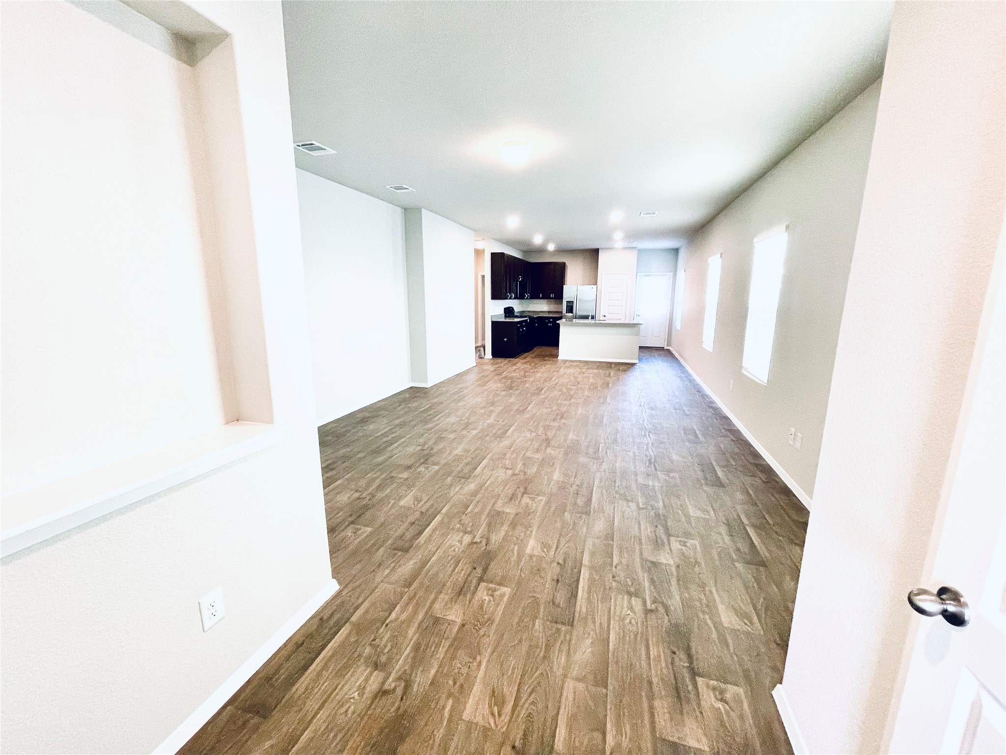 117 Huckleberry Lane Elgin, TX 78621 - Photo 4 of 34 Open plan living room featuring lots of natural light & wood finished floors and baseboards with recessed lighting