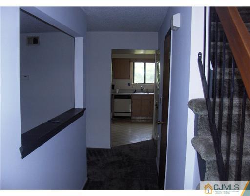 8508 Hana Road Edison, NJ 08817 - Photo 3 of 7 a hallway with couches and wooden floor
