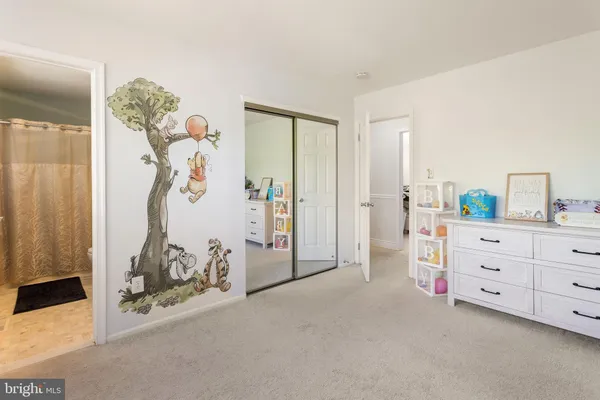 a bathroom with a sink a toilet a mirror and shower curtain