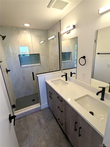 a bathroom with a double vanity sink mirror and double