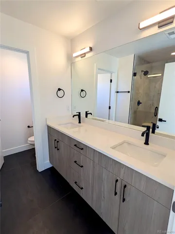 a bathroom with a double vanity sink and mirror
