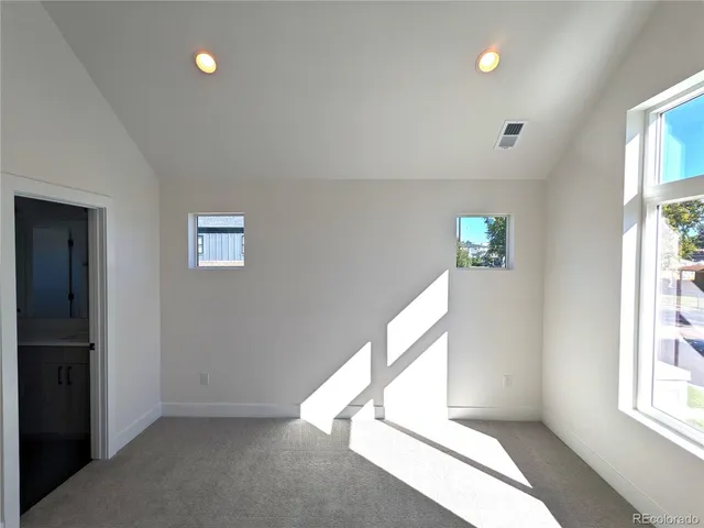 a view of an empty room and a window