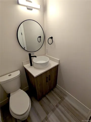 a bathroom with a toilet a sink and mirror