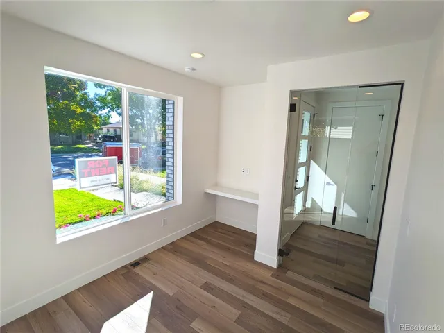 a view of an entryway with wooden floor and door